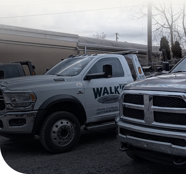 Tow trucks parked outside a building, with the words