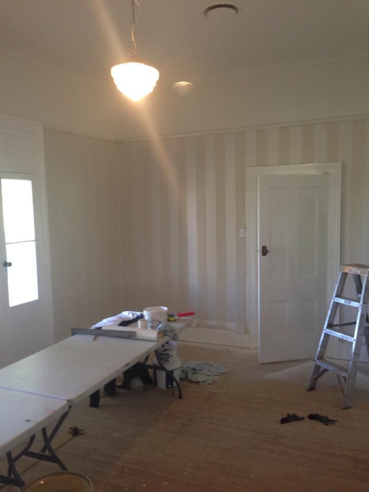 A room with a table and a ladder in it