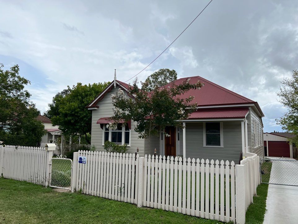 A house with a blue porch and white railing