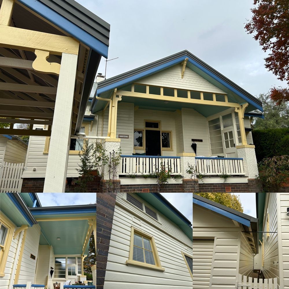 A white house with a blue roof and yellow trim