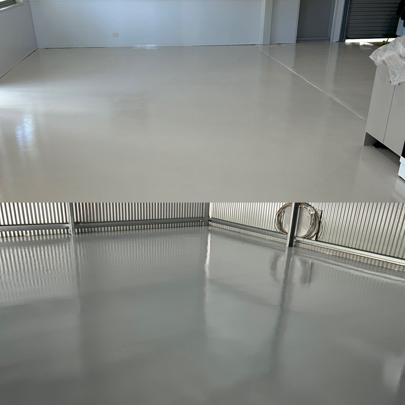 A room with a white floor and a metal fence