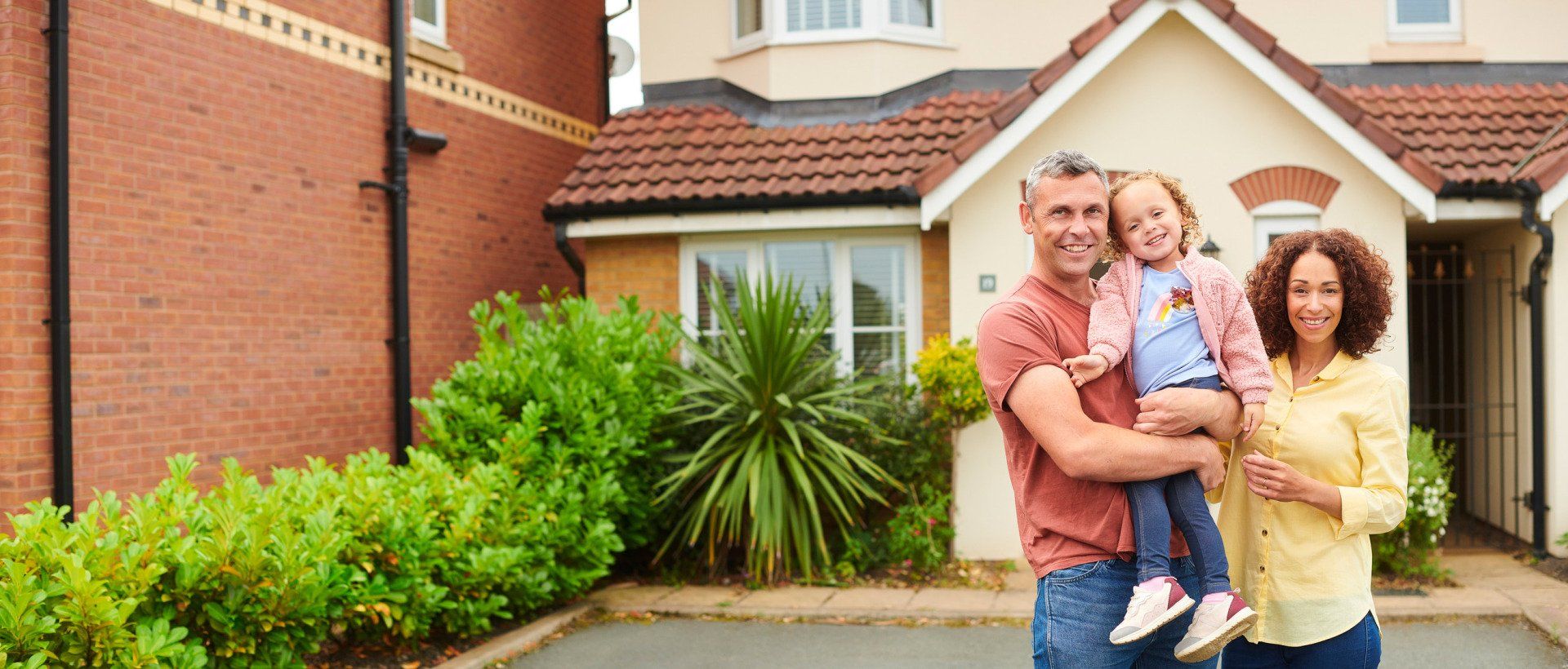Happy Family Portrait Outside Home — Lincoln, NE — Advantage Insurance Agency