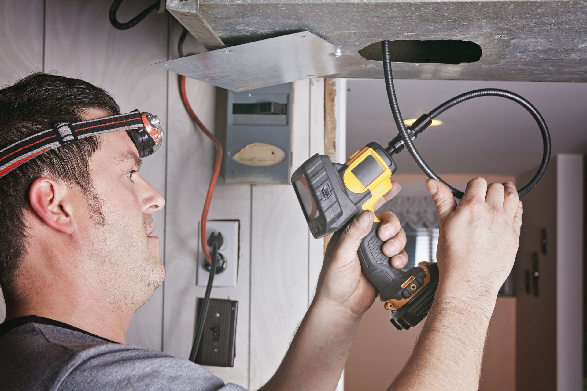man using a tool for radon inspection