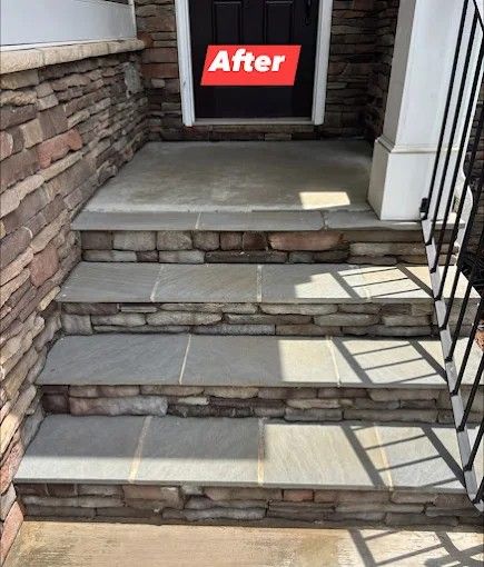 Stone steps leading up to a front door with a
