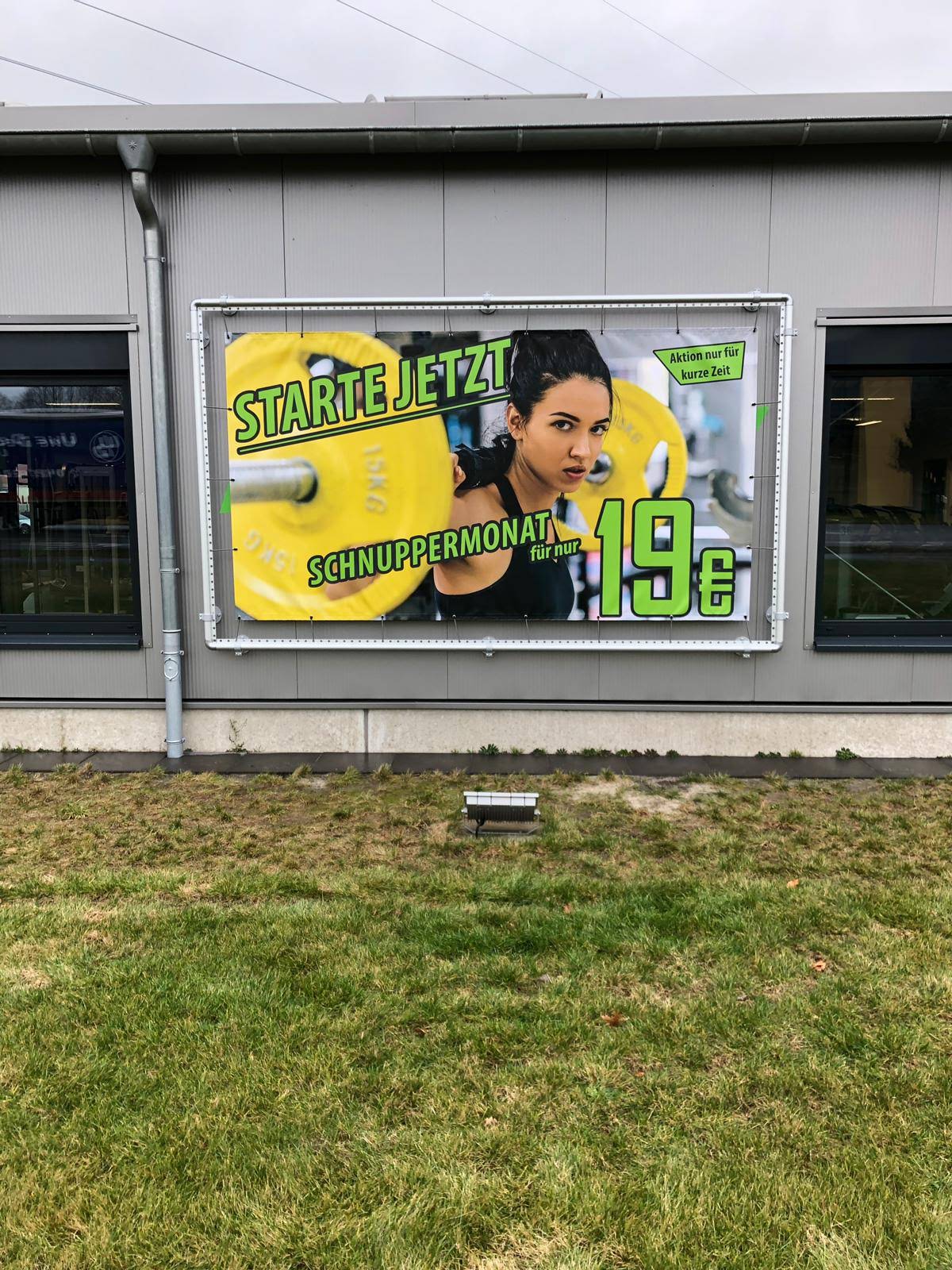 Advertisement: Woman lifting weights, text 