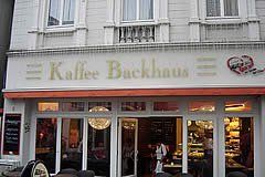 Außenansicht der Bäckerei Kaffee Backhaus mit Markise und Schaufenstern.