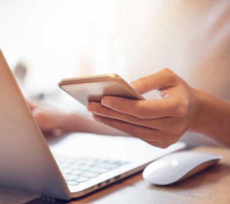 Woman Holding Cellphone — Orange Park, FL — Andersen Insurance Group