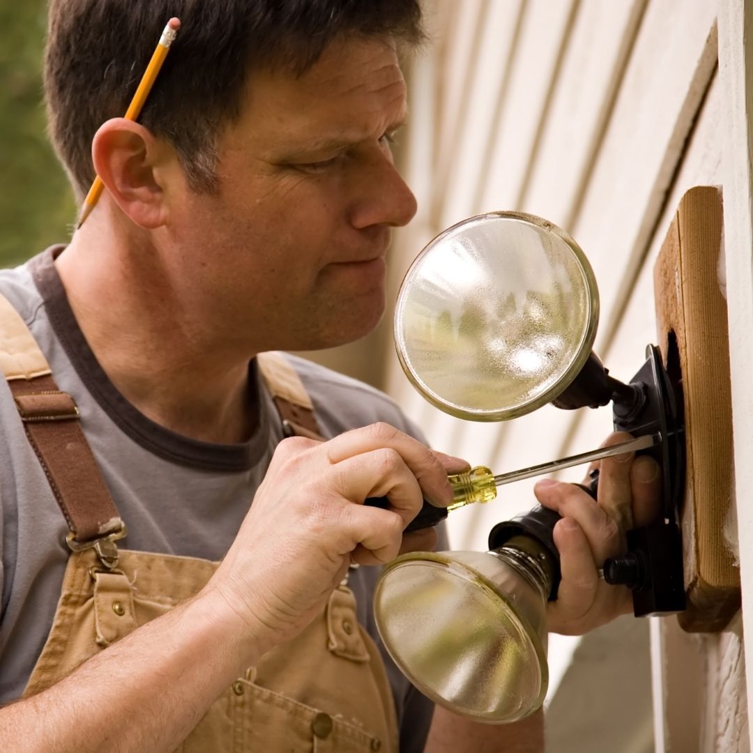 technician installing flood lights