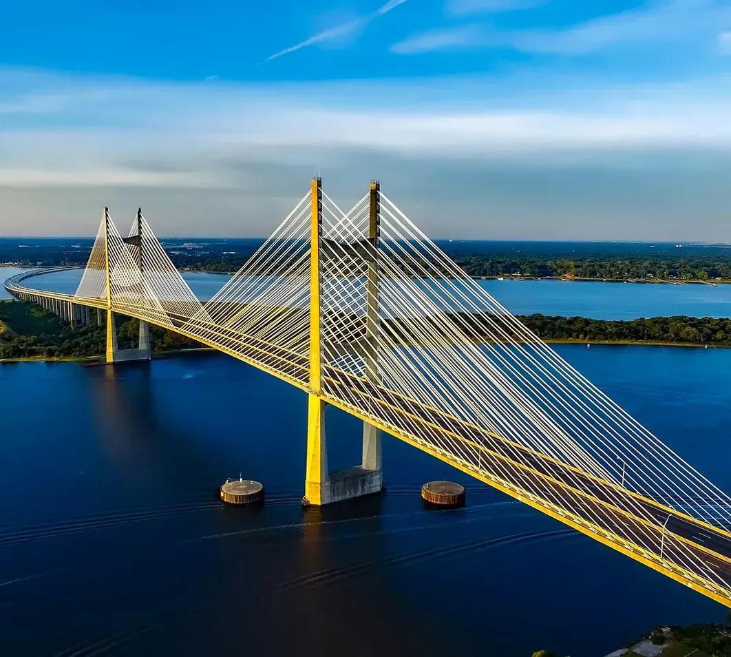 An aerial view of a bridge over a body of water.