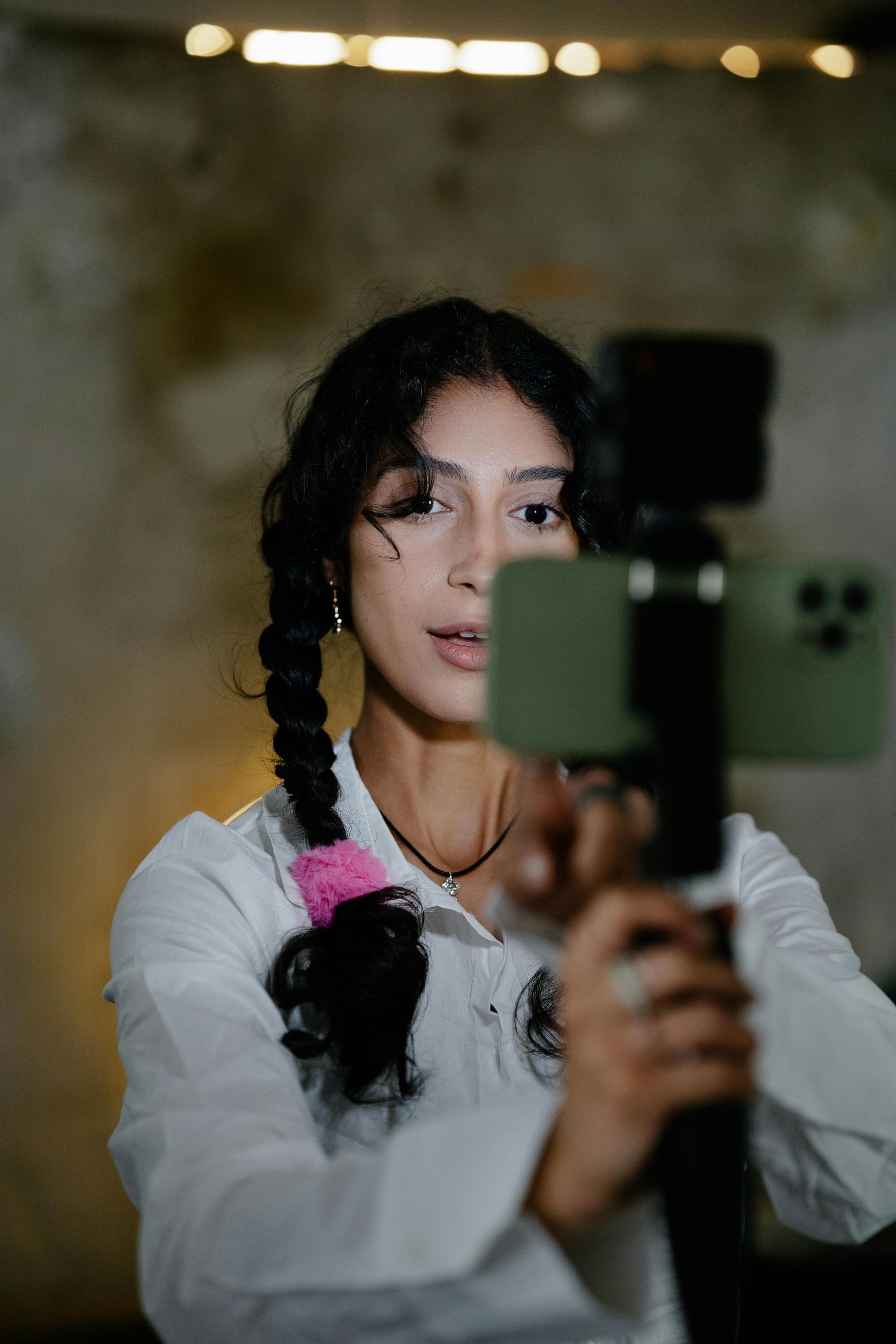 A woman is taking a picture of herself with a camera.
