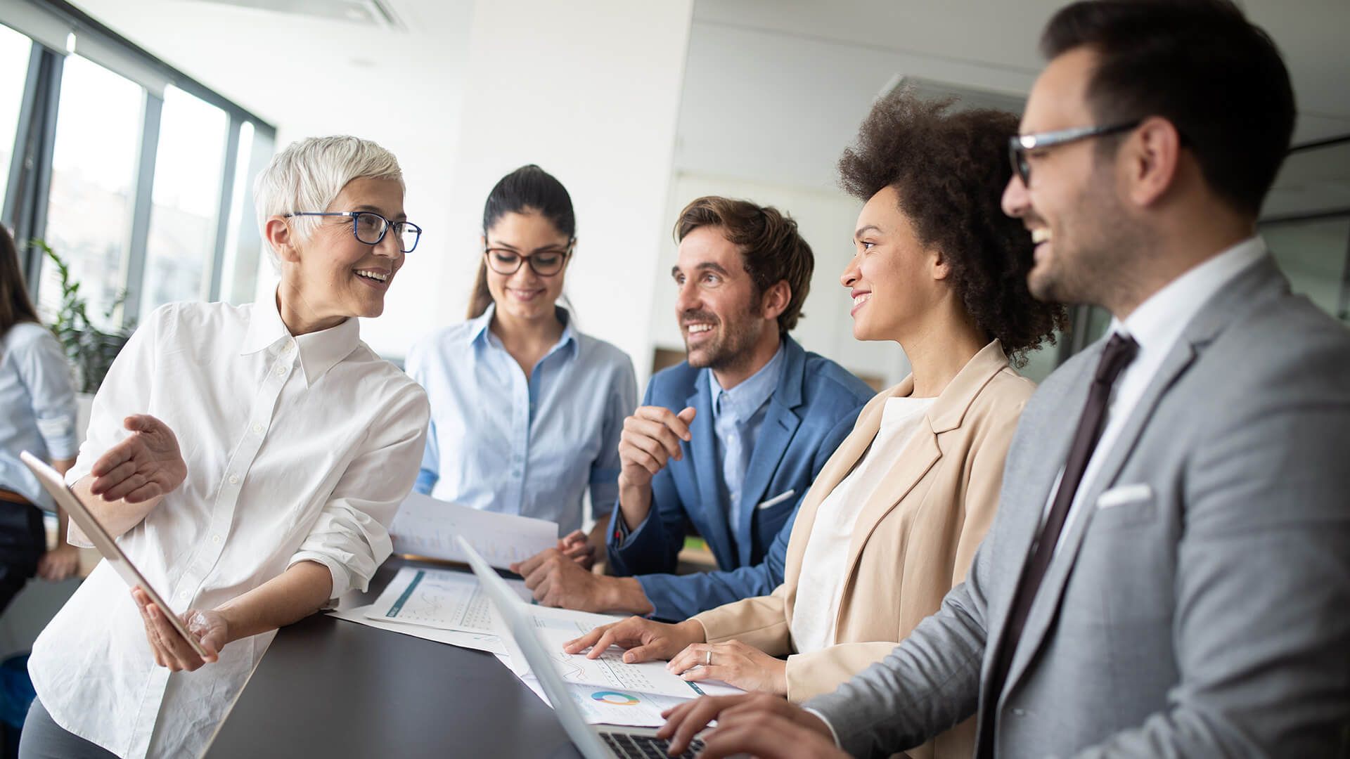 Happy business colleagues in modern office working together