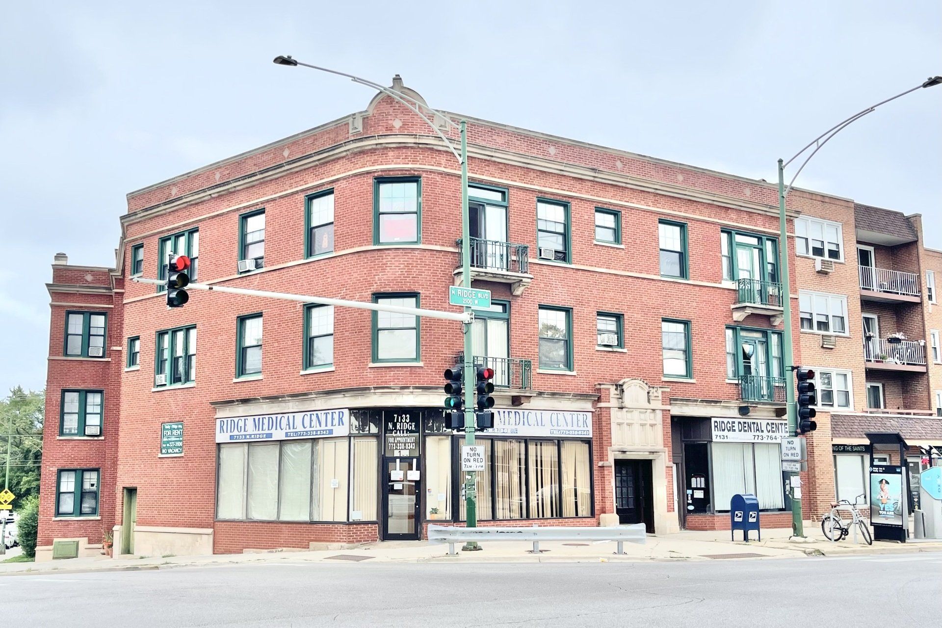Exterior of 7131 N. RIDGE BUILDING with retail stores on the first floor.