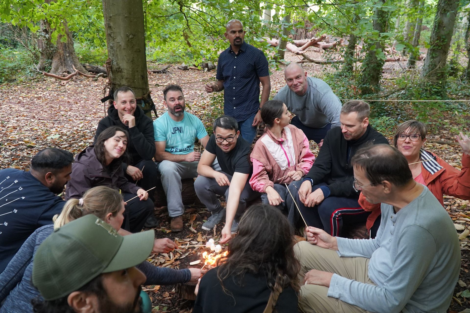 Corporate Team sat around a fire discussing their Bristol Team Building Day outdoor activities near me