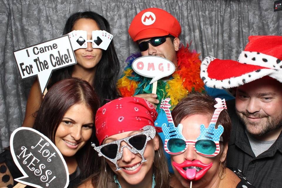 A group of people posing for a photo with a sign that says i came for the cake