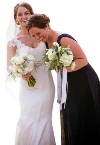 A bride and her bridesmaid are posing for a picture