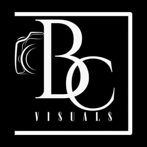 A white logo with a camera in a square on a black background.