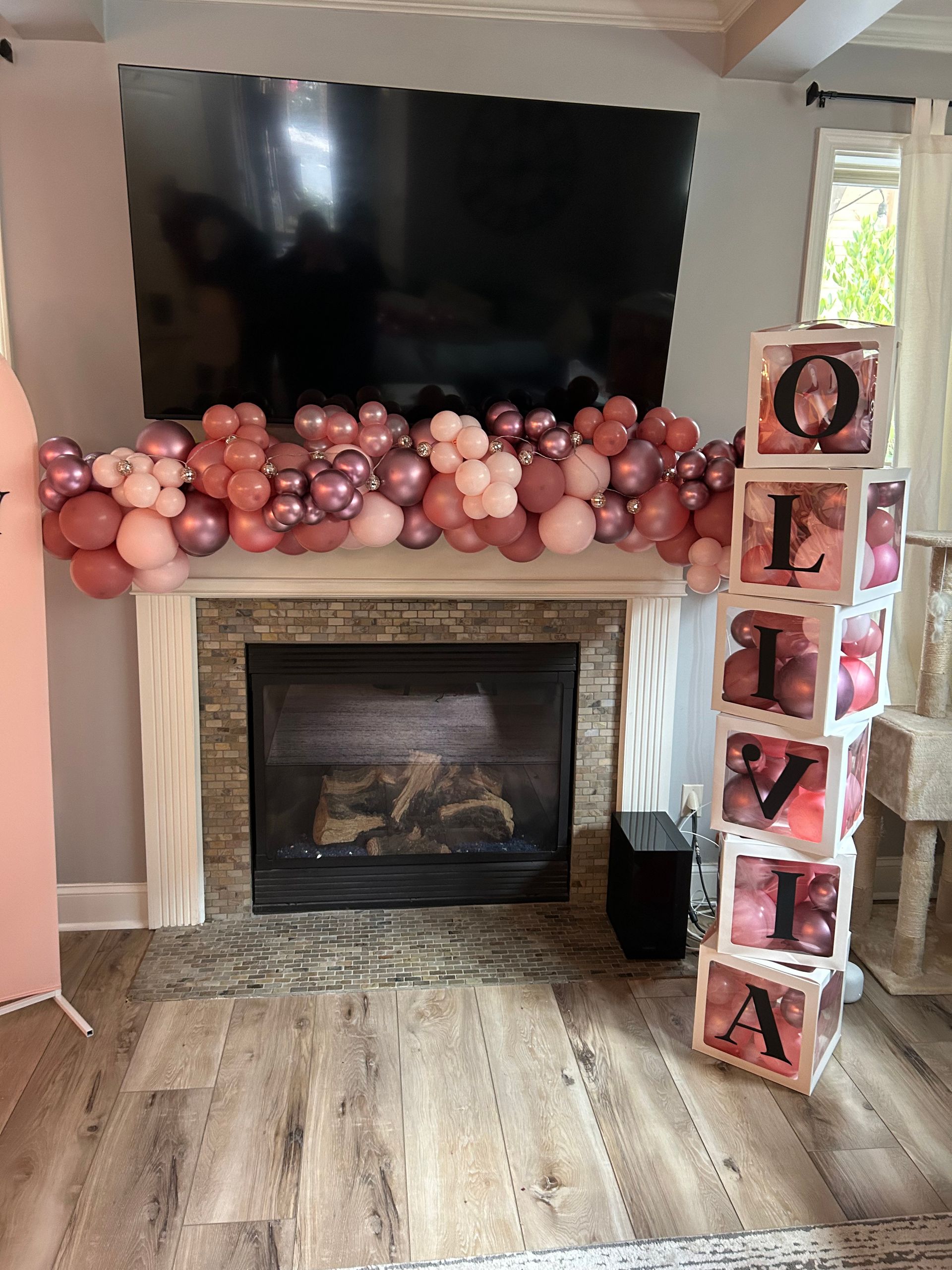 A living room decorated for a baby shower for a girl.