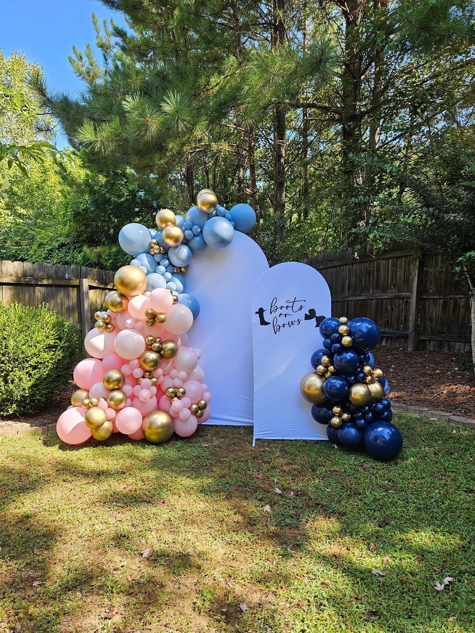 A bunch of balloons are sitting on top of a lush green field.