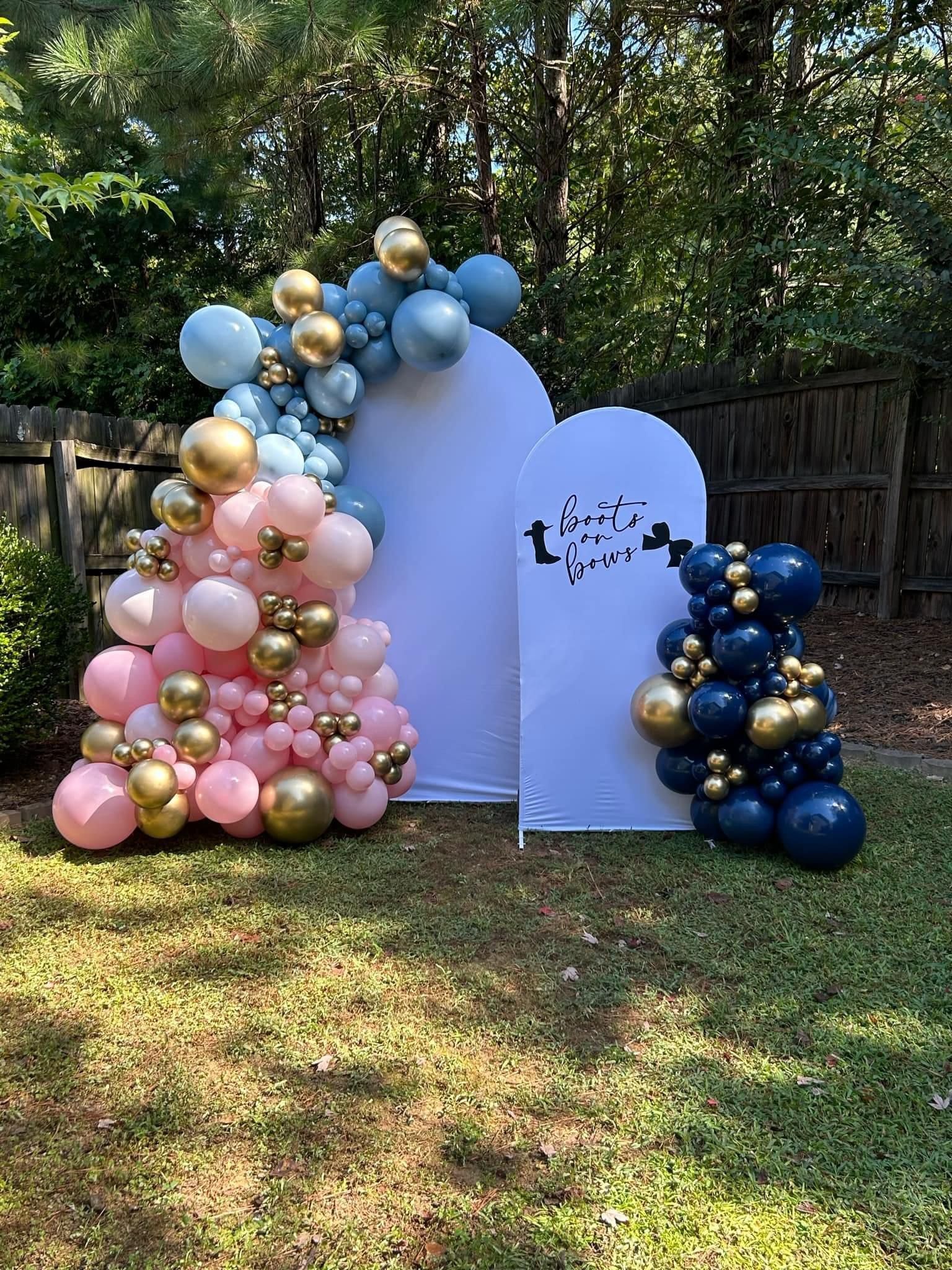A bunch of balloons are sitting on top of a lush green field.