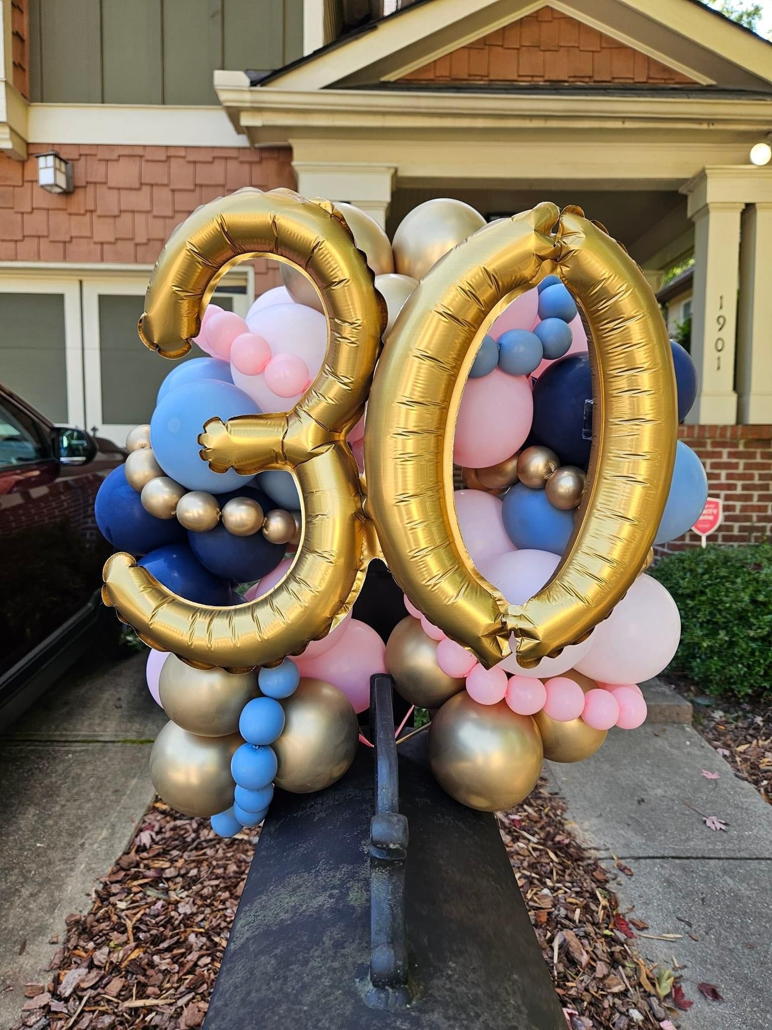 A bunch of balloons with the number 30 on them