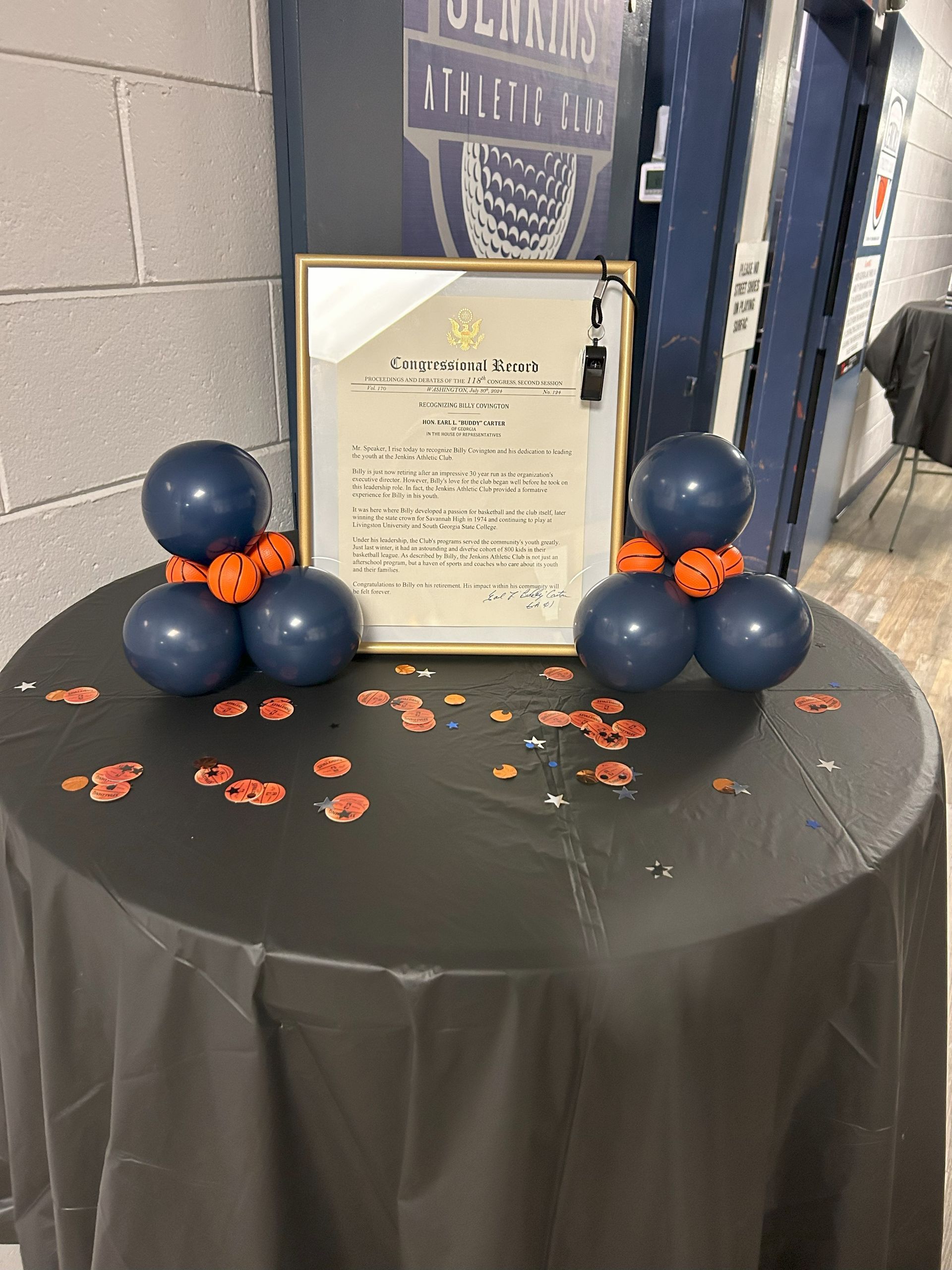 A table with balloons and a certificate on it