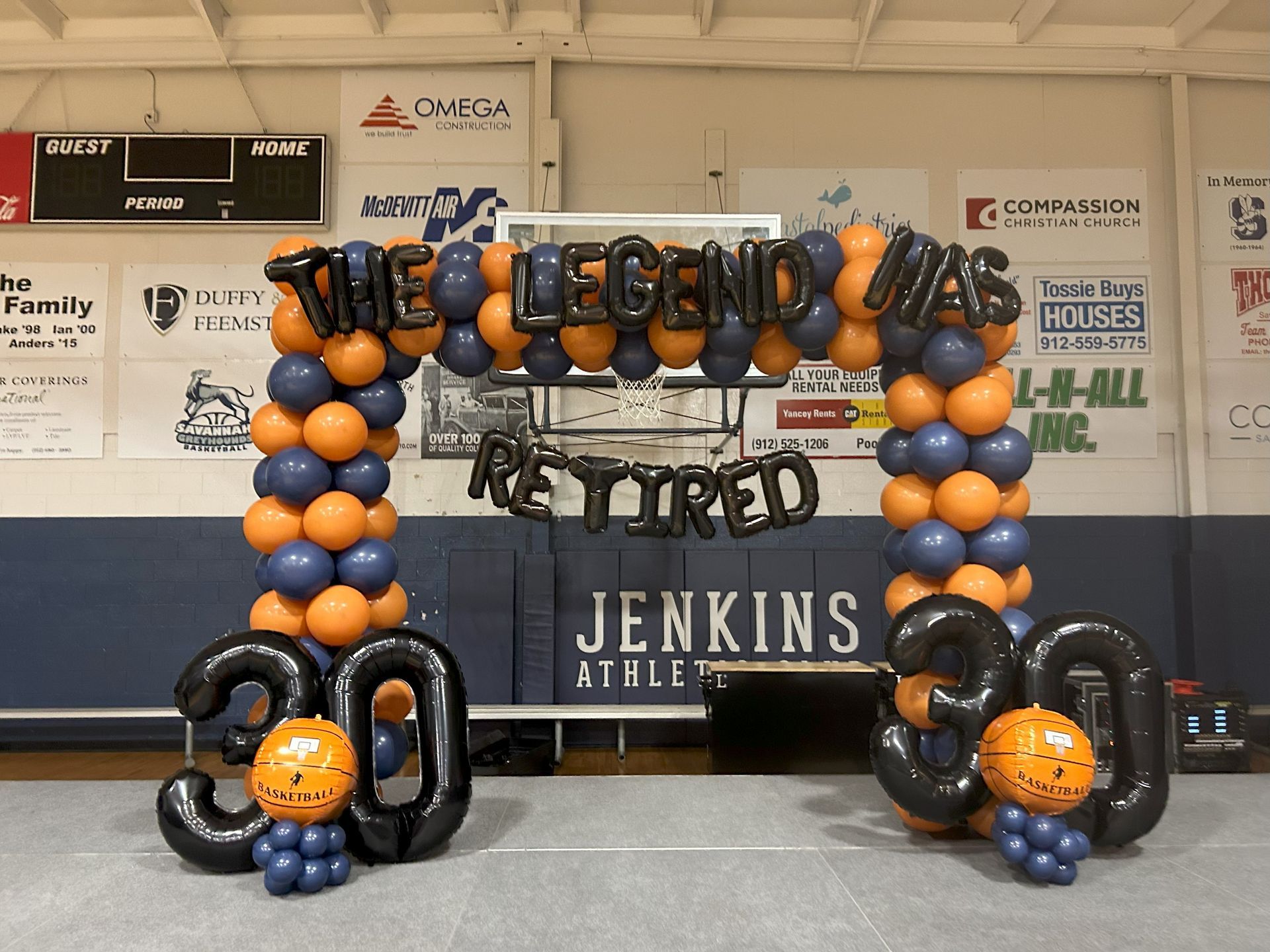 A balloon arch that says the legend was retired