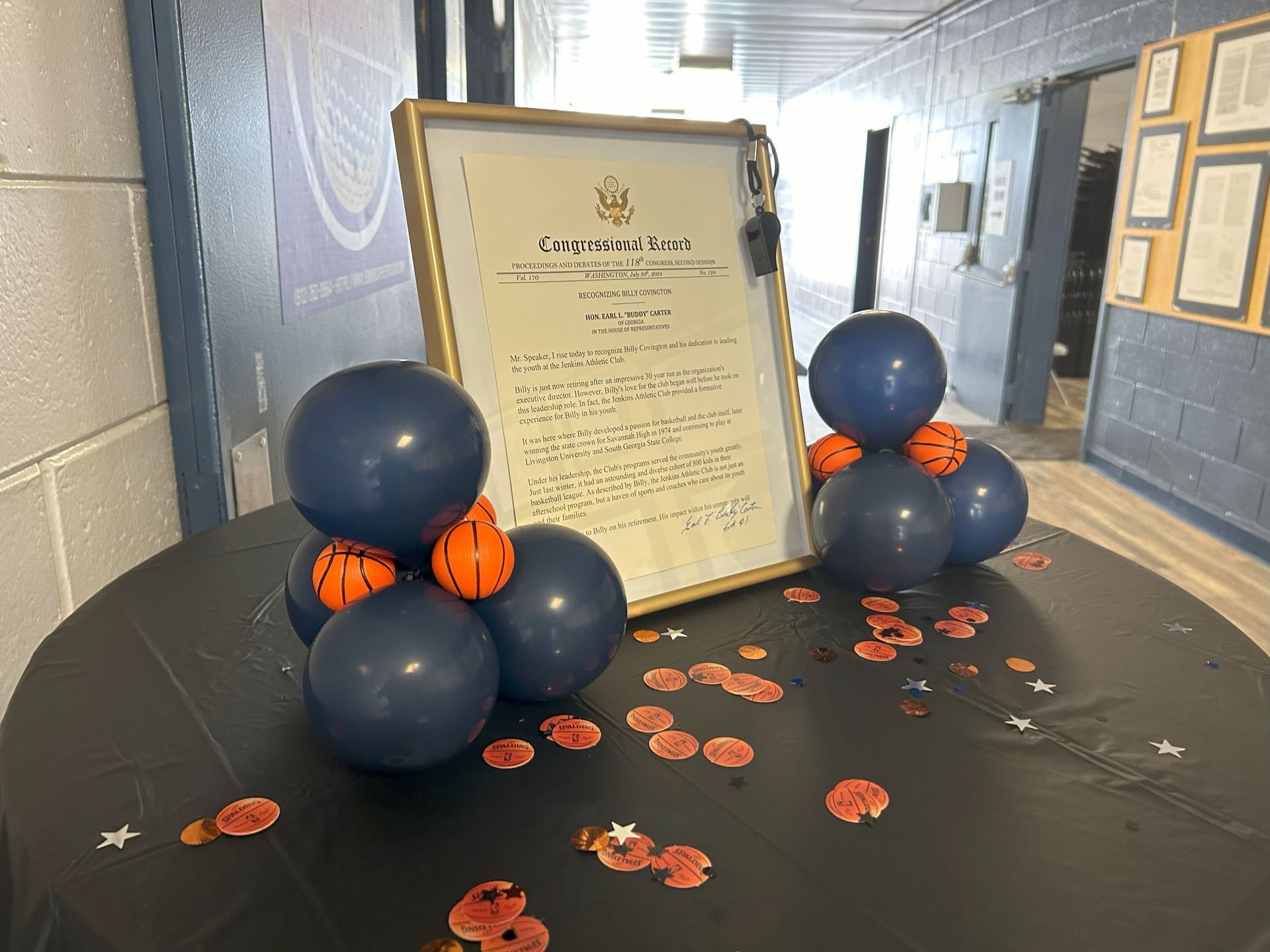 A table with balloons and a certificate on it