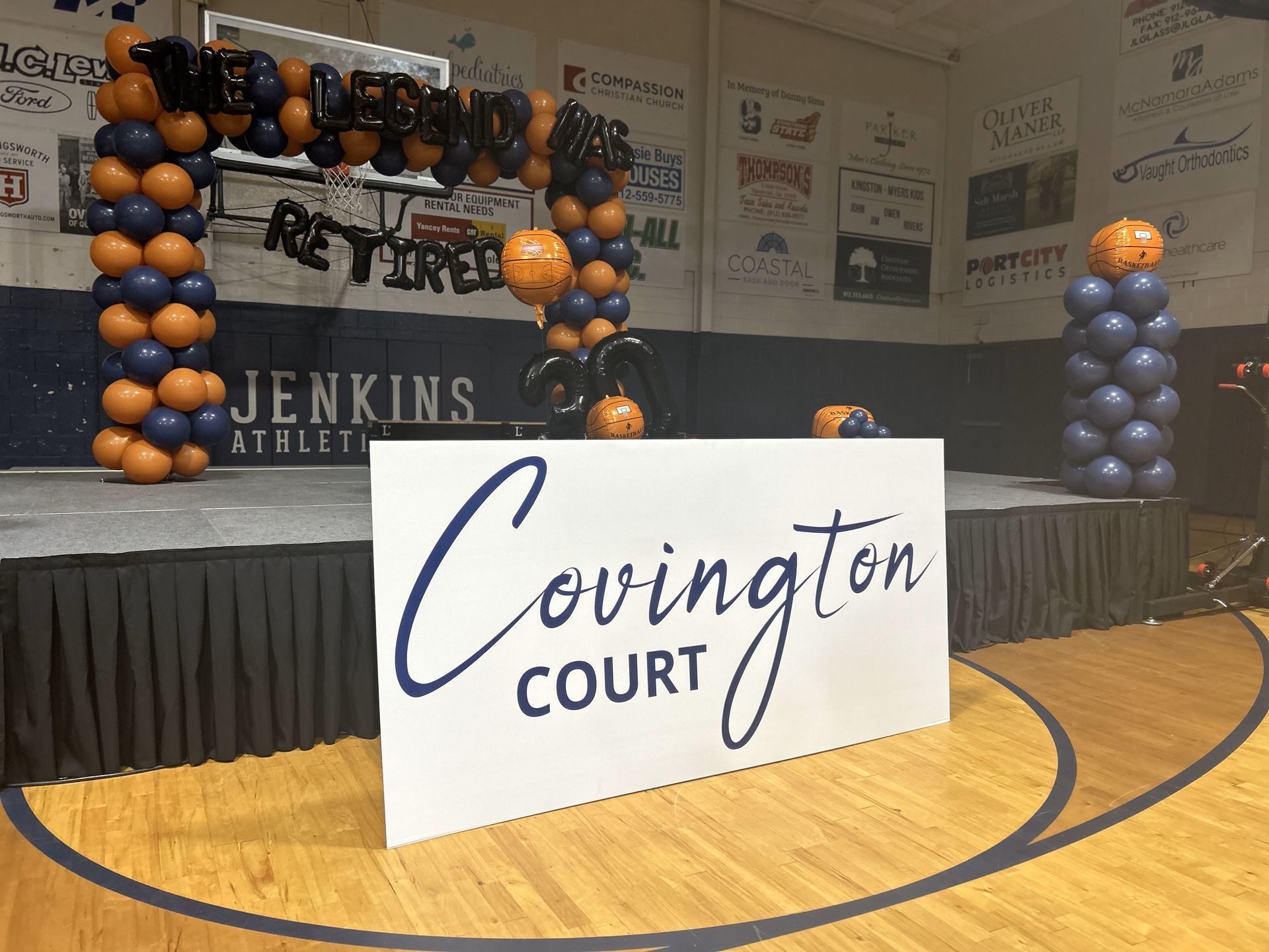 A stage with balloons and a sign that says covington court