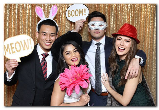 A group of people are posing for a picture in a photo booth.