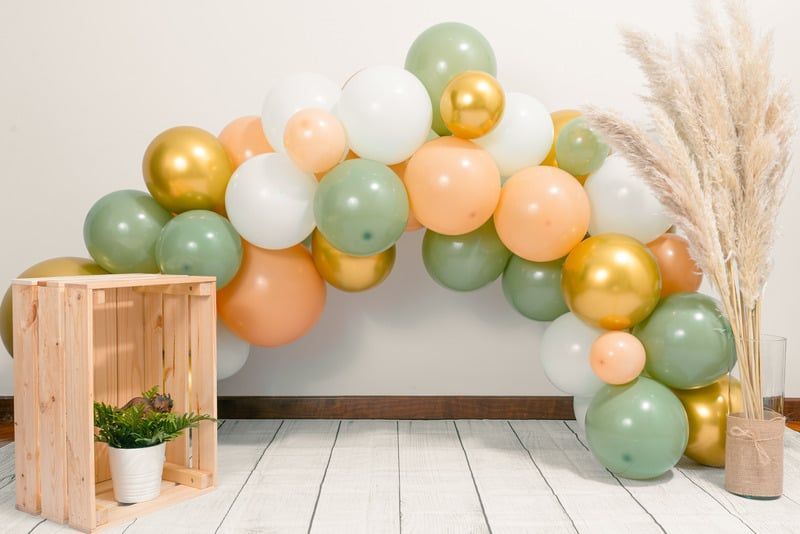 A bunch of balloons are sitting on the floor in a room.