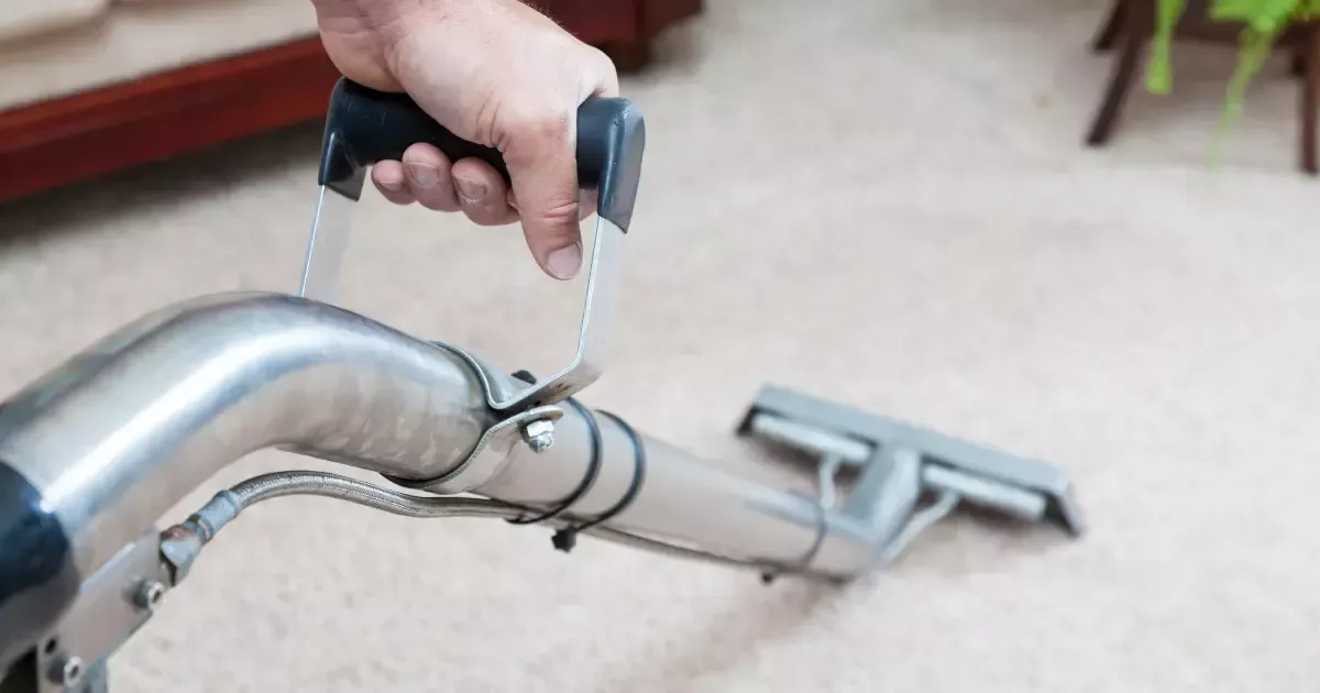 A hand holding a vacuum cleaner