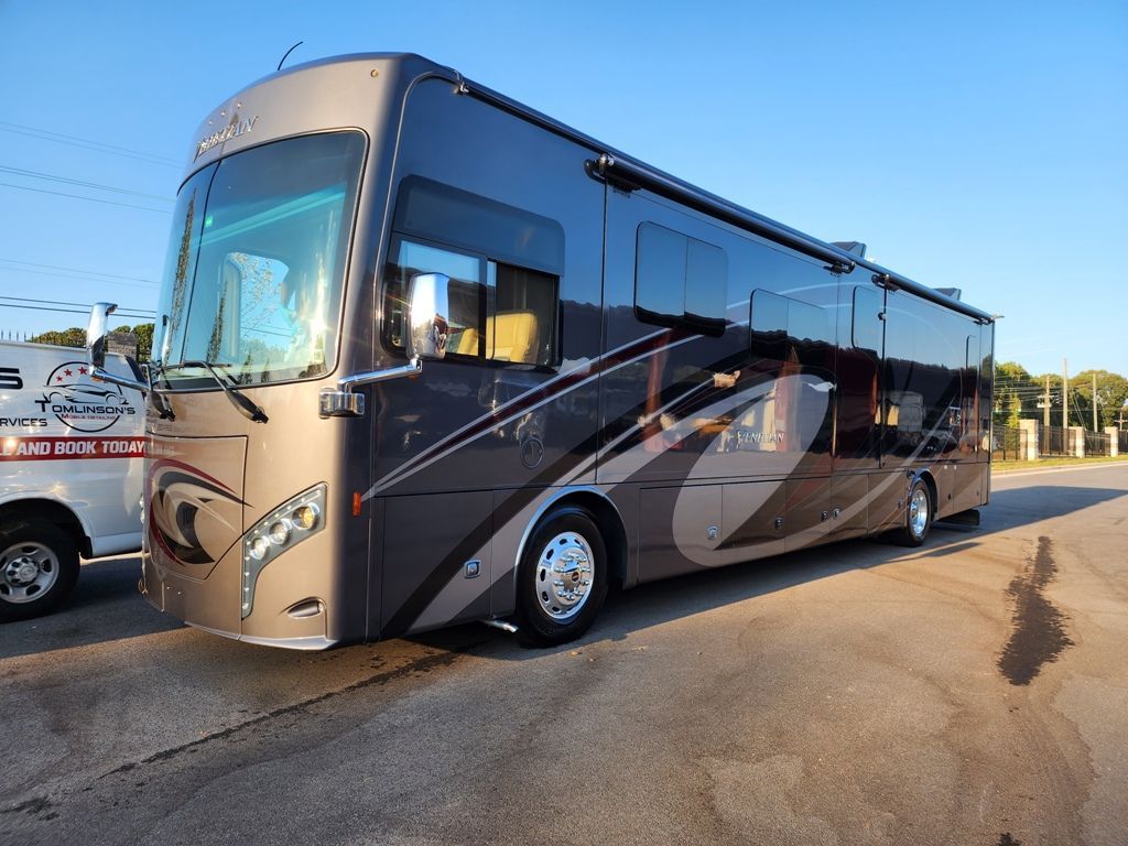 A large rv is parked on the side of the road.