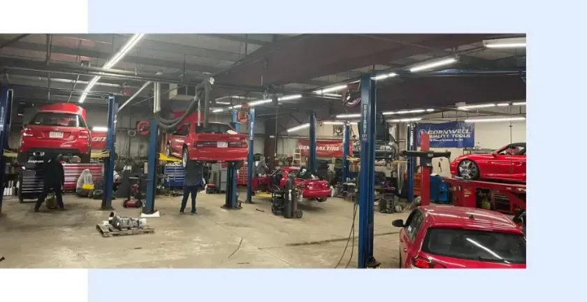 A lot of cars are being worked on in a garage - FasTrack Automotive, Inc.