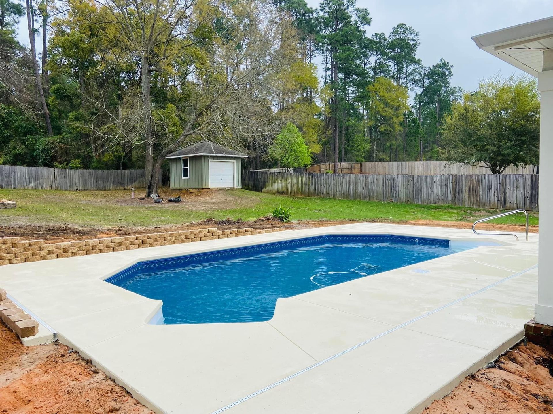 A large swimming pool in the backyard of a house