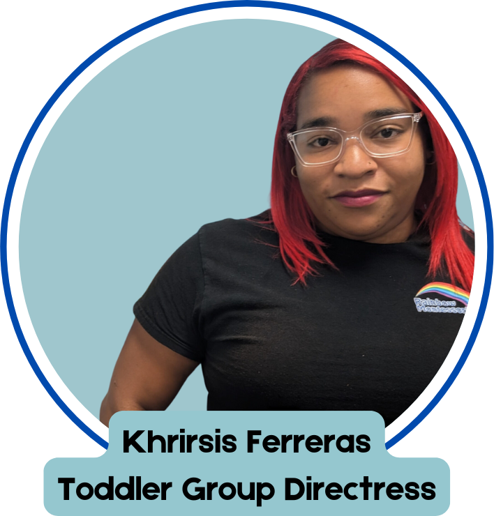 A woman with red hair and glasses is a toddler group director