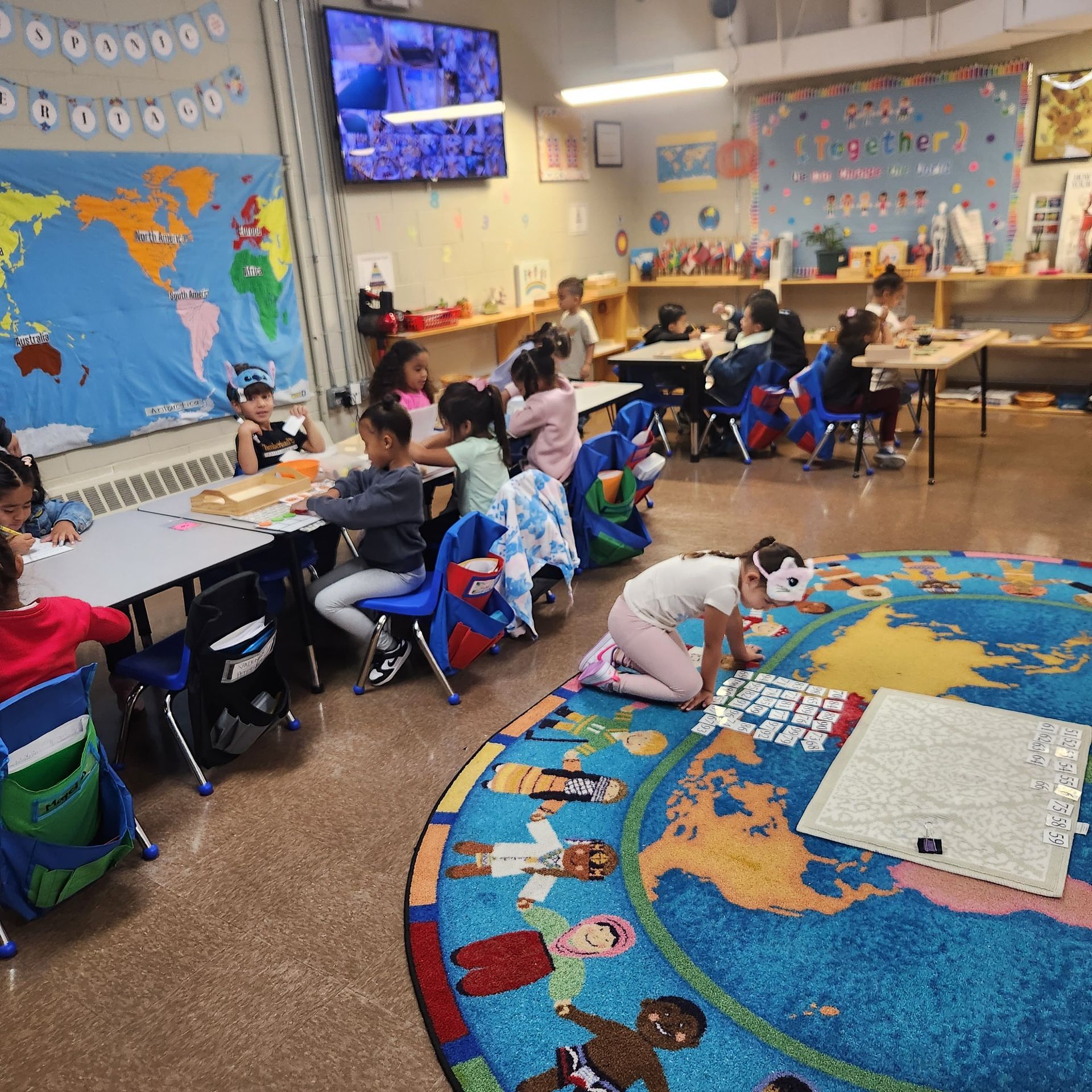 Children learning with Montessori activities on the rug