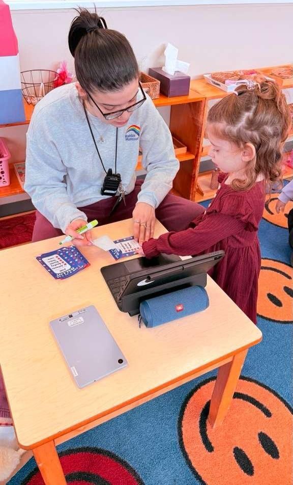 Teacher showing student how to do a task