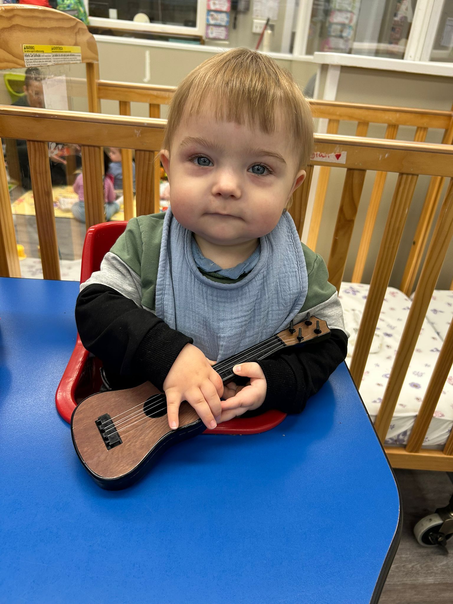 Toddler playing guitar