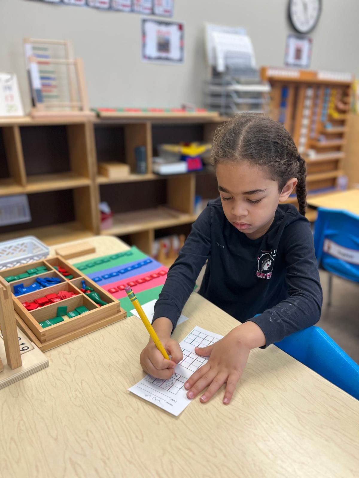 A group of children are sitting on the floor listening to a story.