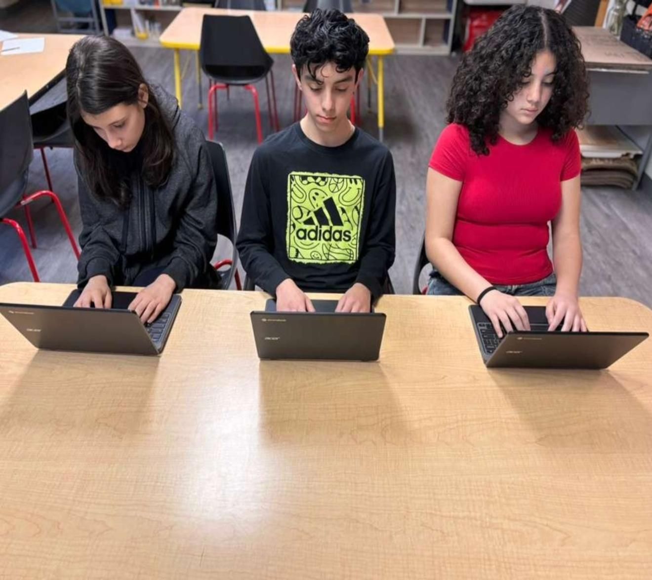 8th graders learning on their chromebooks