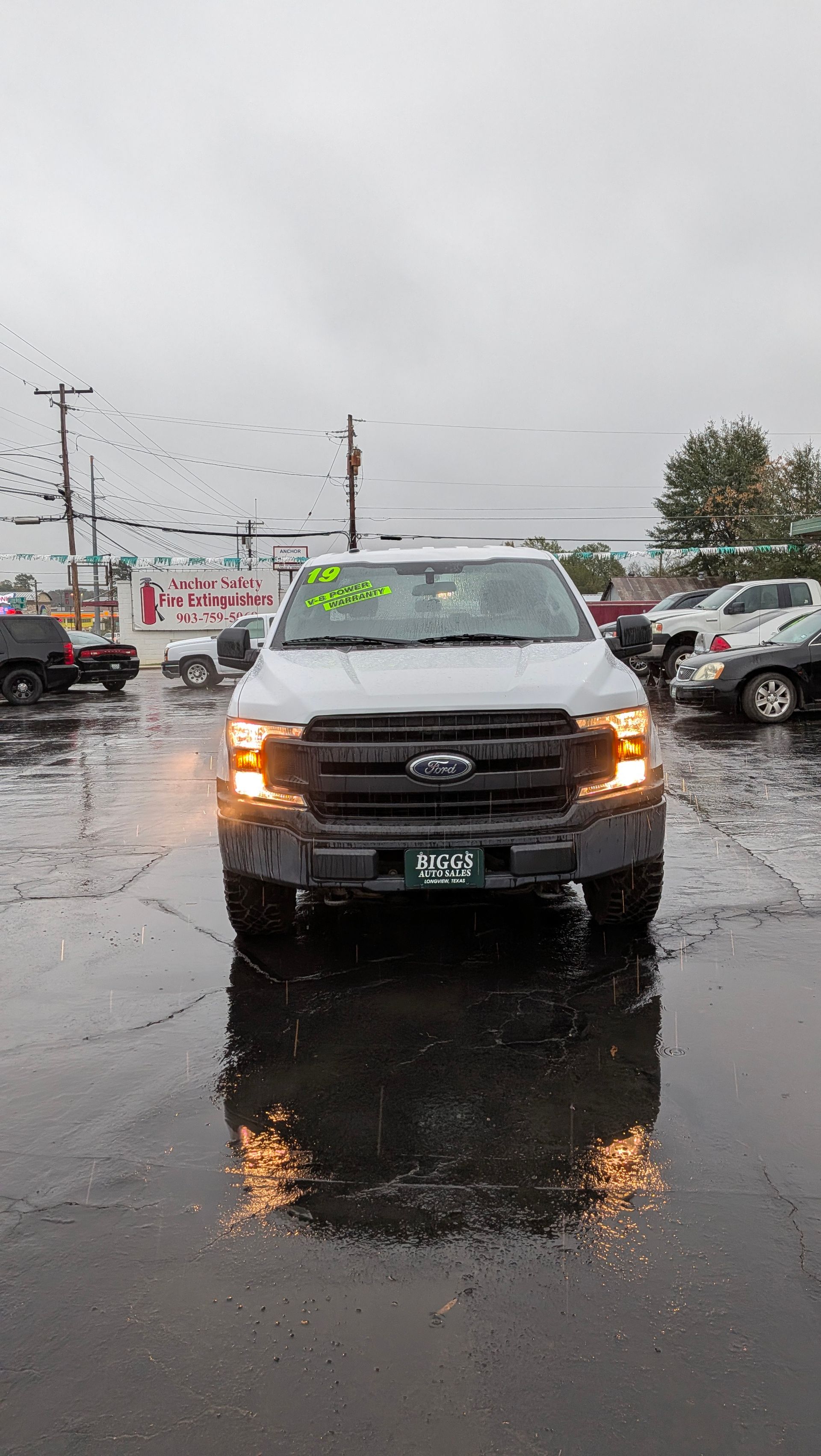 Black Dodge Ram truck parked on pavement.