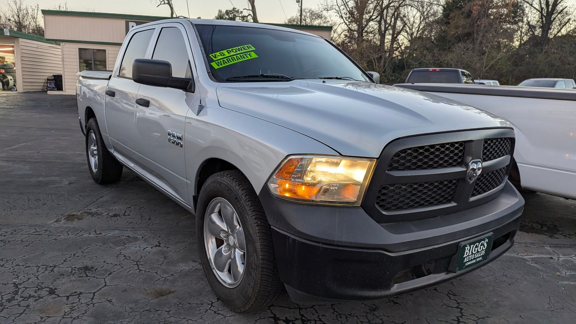 Silver Dodge Ram pickup truck parked outside on an overcast day.