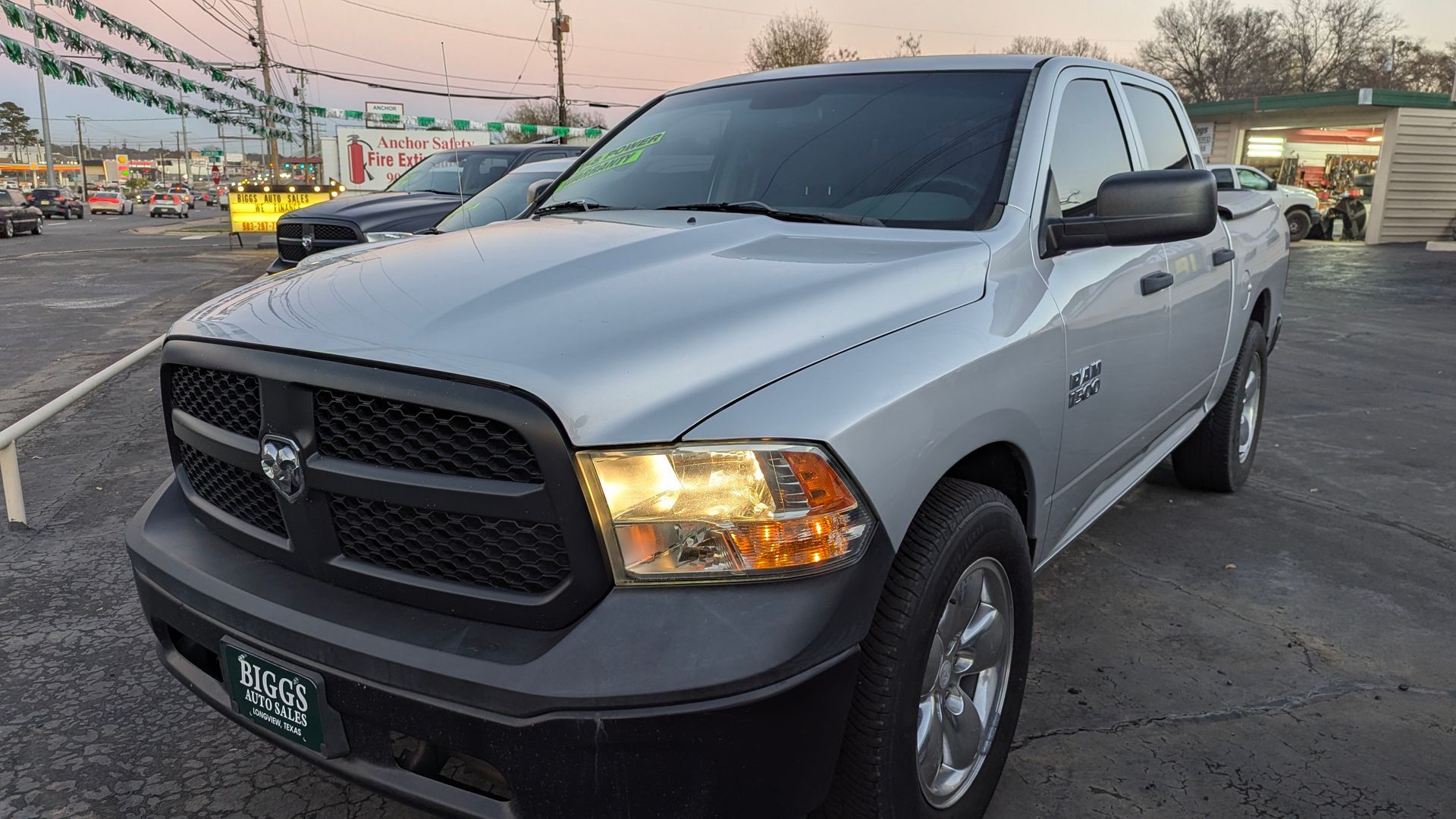 Silver Dodge Ram pickup truck in a car lot.