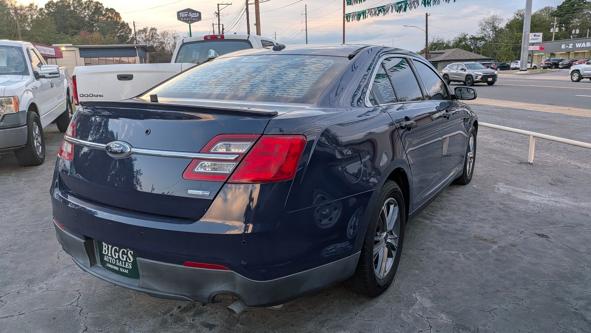 Dark blue Ford Taurus sedan parked on a car lot.
