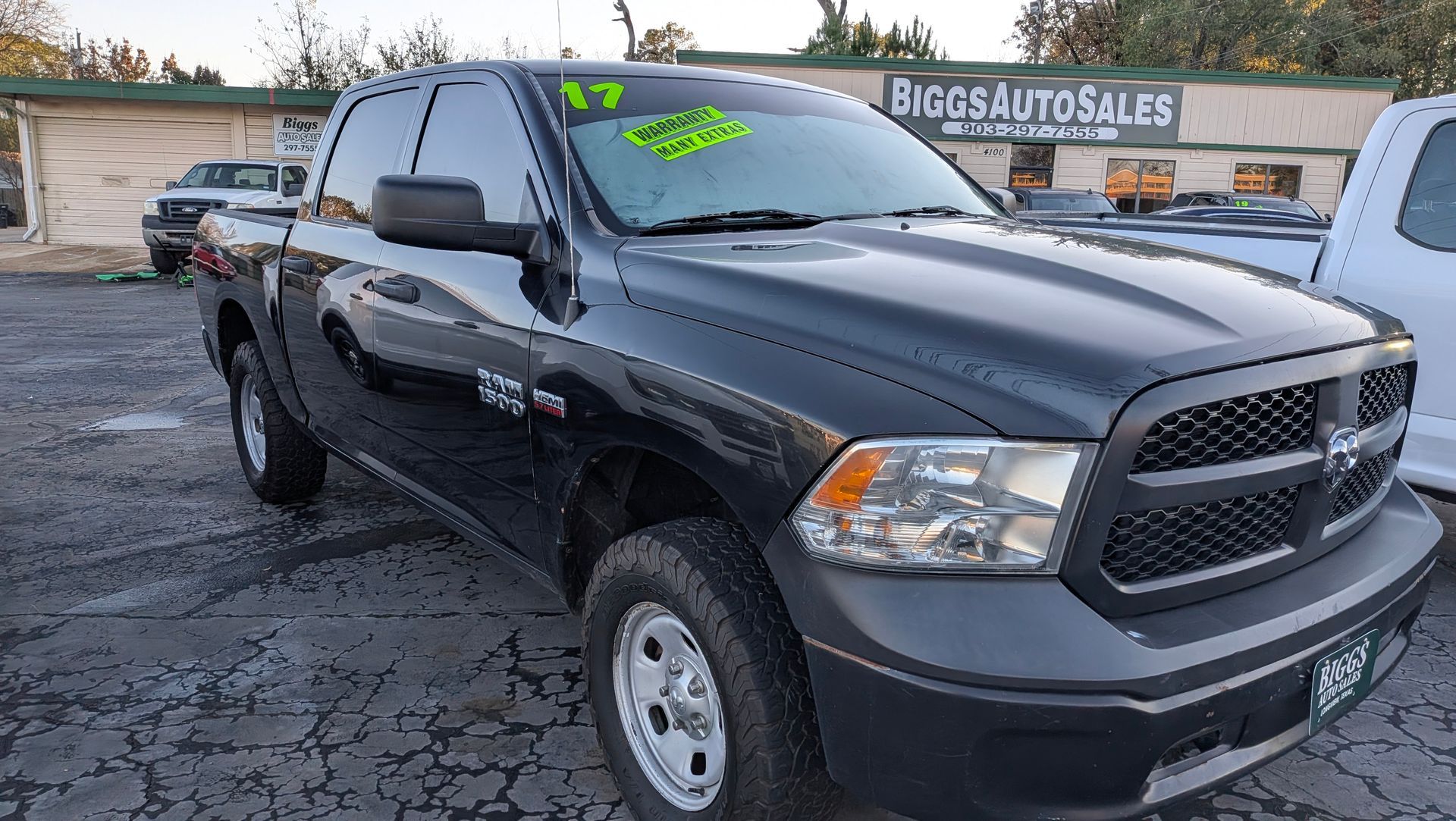 Black 2017 Dodge Ram pickup truck parked outside Biggs Auto Sales.