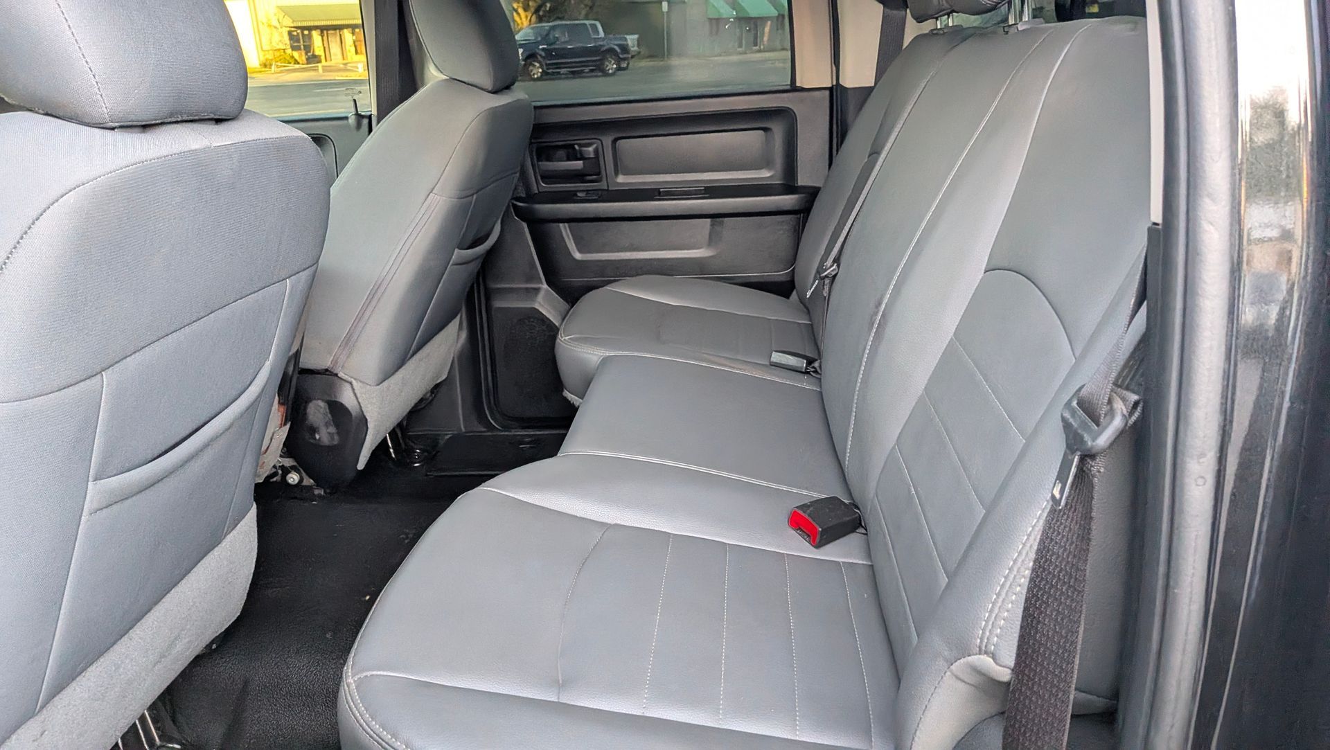 Gray leather truck backseat.