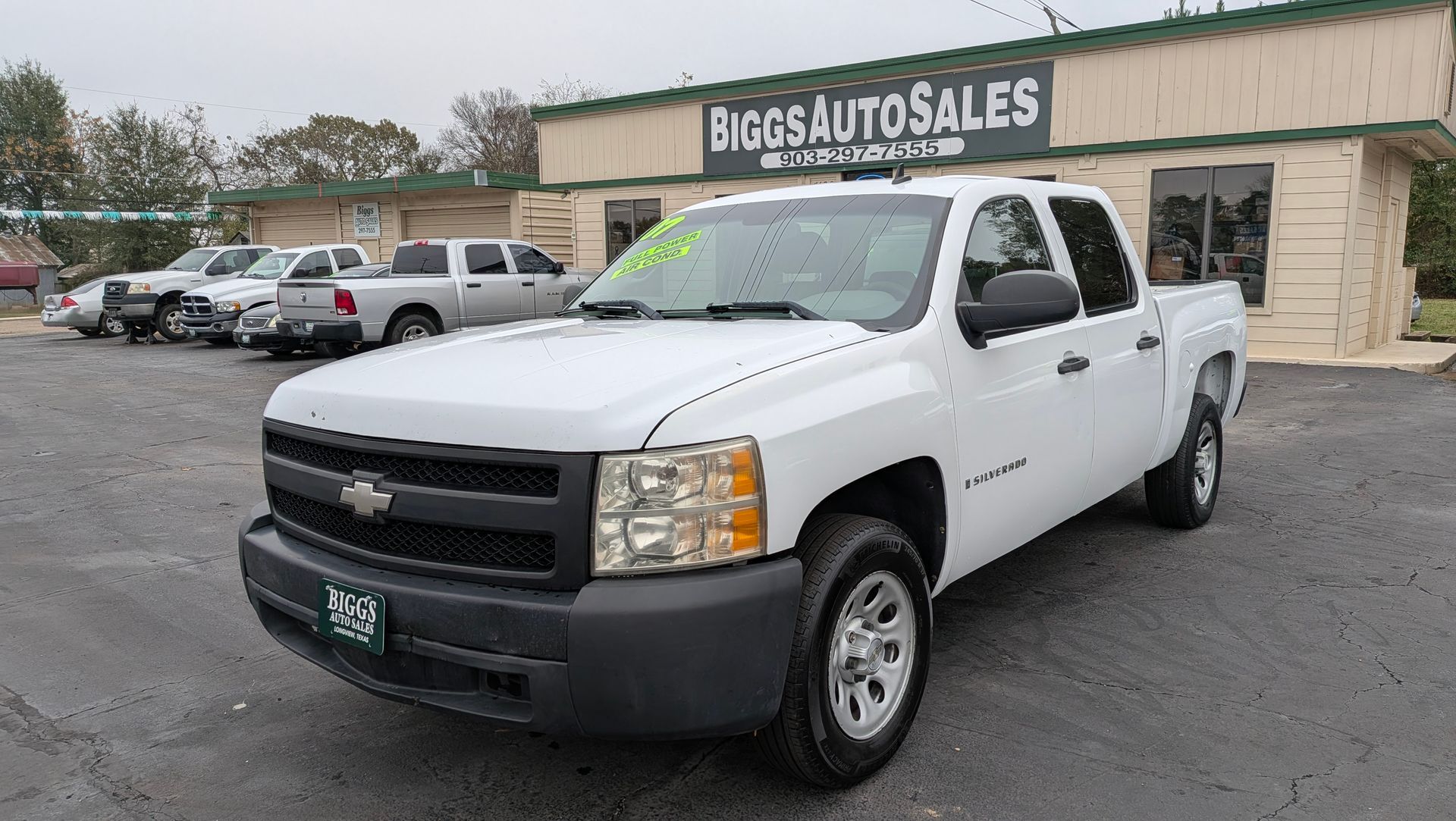 White Chevrolet Silverado truck parked in front of 