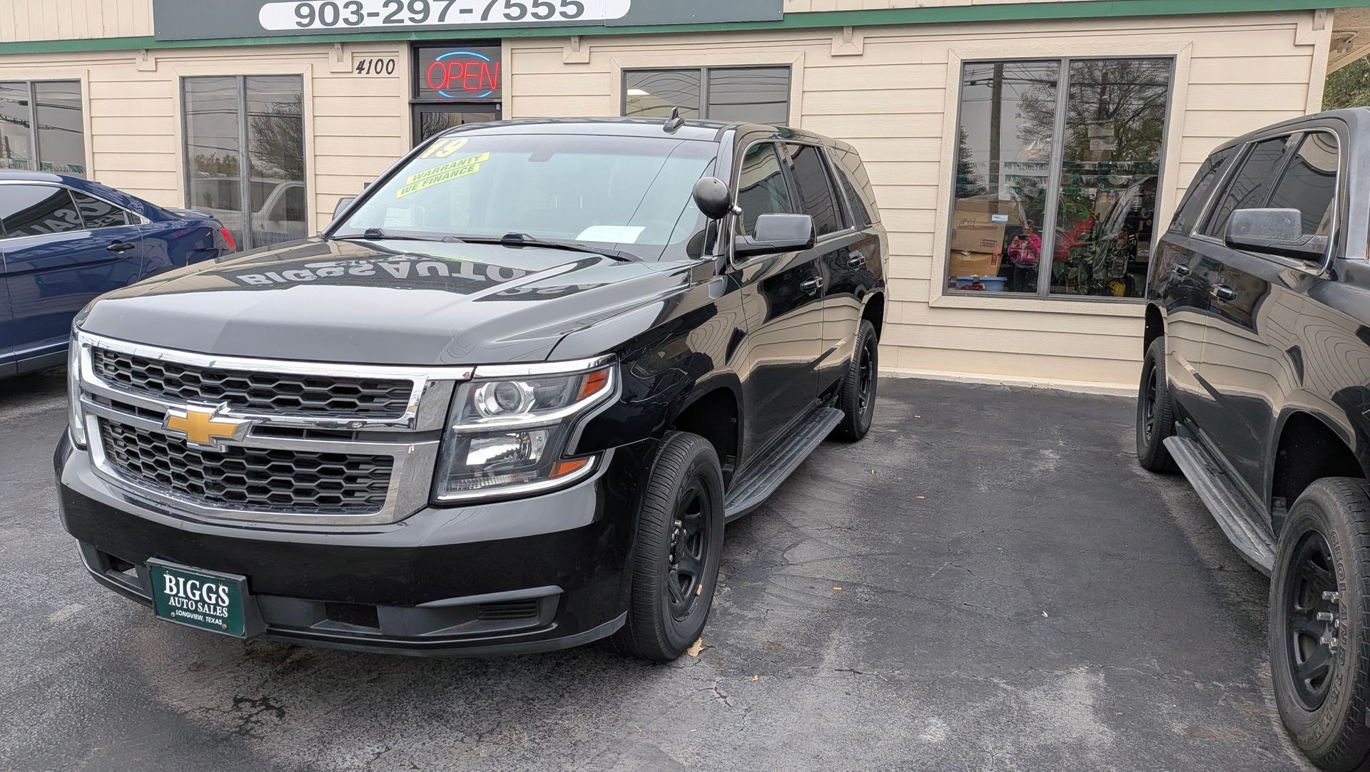 Black Chevrolet Tahoe SUV parked outside a building.