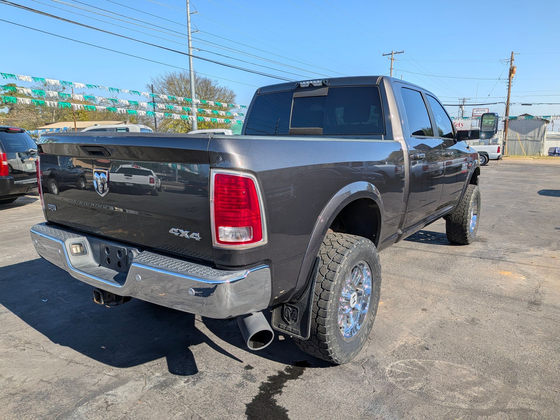 Dark gray Ram pickup truck parked on pavement on a sunny day.
