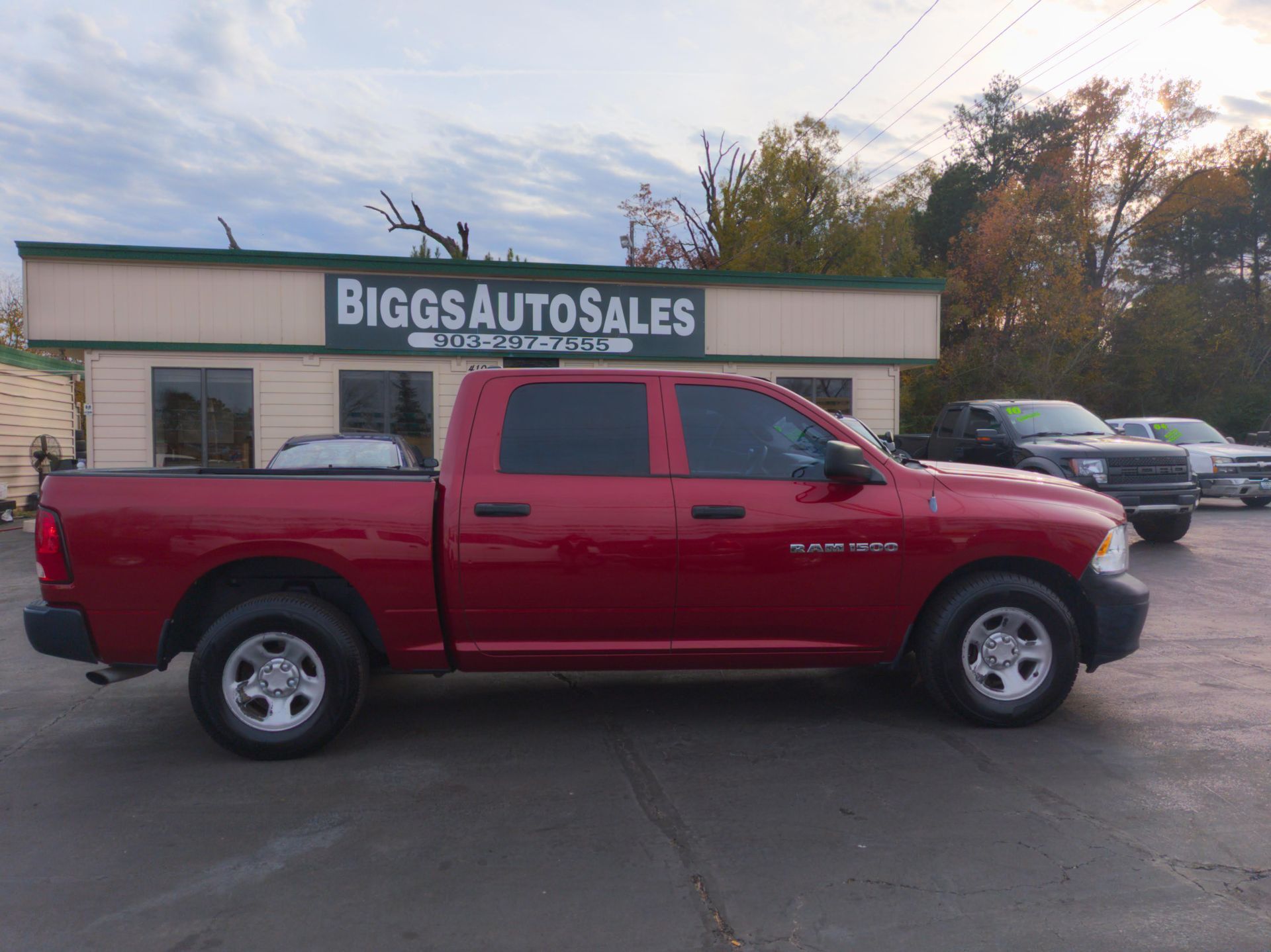 Red Dodge Ram truck parked in front of 